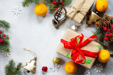 Christmas background. Christmas decor of a table, gifts and tangerines on a stone background. Flat...