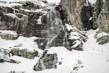 Waterfall in mountains at winter © Jaroslav Moravcik