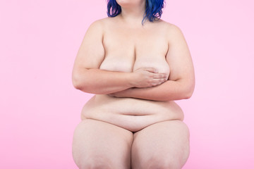 Plus size model in front of pink background