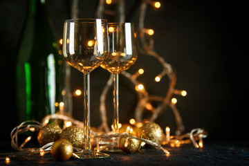 Glasses for wine and golden Christmas balls