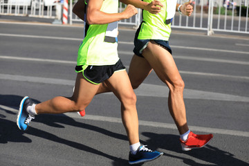 Fototapeta premium Marathon runners running on city road