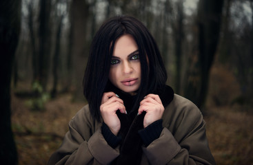 Portrait of a girl in the forest. Green eyes. Autumn forest.