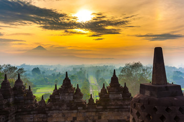 Taman Lumbini park from the height of the temple complex Candi Borobudur at sunrise in the fog....
