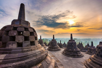 Taman Lumbini park from the height of the temple complex Candi Borobudur at sunrise in the fog....
