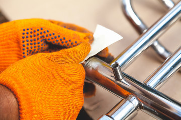 Stripping  with sandpaper of stainless heated towel rail
