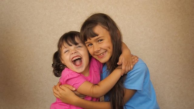 The American flag covers happy children. Little girls hug and scream.