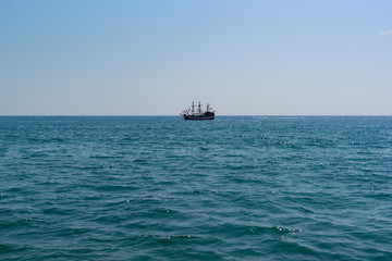 Sailing ship on calm on the horizon