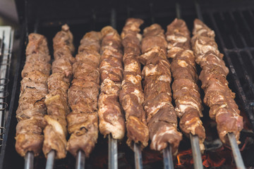 Grilling marinated shashlik on a grill.