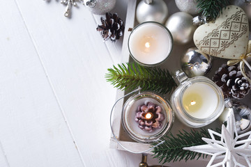 Christmas Christmas card with glowing small candle and fir cones