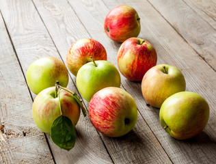 Ripe red apples on wooden background
