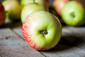 Ripe red apples on wooden background