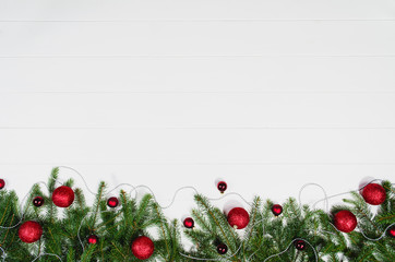 Christmas background frame top view on white wooden plank table background with copy space around products. Decorations isolated on white. Horizontal composition.