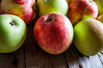 Ripe red apples on wooden background
