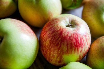 Ripe red apples on wooden background