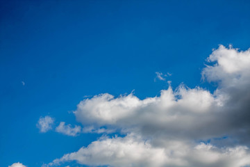 Light white thick clouds in contrast with the bright blue sky