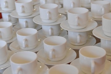 Empty white cups with plates 
