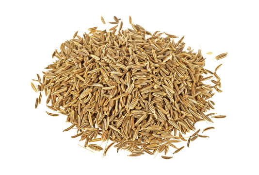 Close up pile of cumin seeds isolated on white background