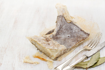 dry salted cod fish on wooden background
