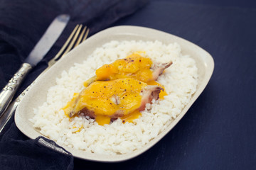 boiled fish with sauce and boiled rice on white dish