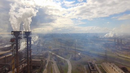 Fototapeta premium Aerial view of industrial steel plant. Aerial sleel factory. Flying over smoke steel plant pipes. Environmental pollution. Smoke.
