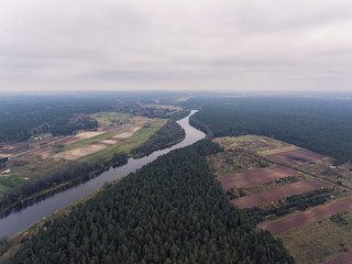 Aerial view over cloudy river Nemunas valley near border in Lithuania.
