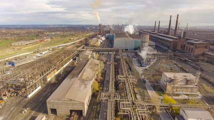 Aerial view of industrial steel plant. Aerial sleel factory. Flying over smoke steel plant pipes. Environmental pollution. Smoke.