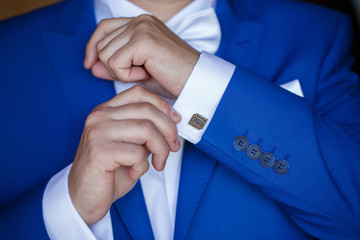 a man wearing a blue jacket and white shirt for the wedding