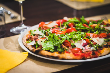 Real italian pizza with fresh tomato and rucola