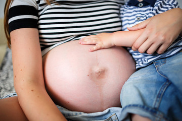 The baby hugs a mother's belly