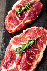 Raw meat, beef steak on black background, top view