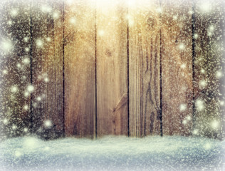  glow of festive lights and a wooden background in the snow. Christmas background. New Year. Snowstorm.