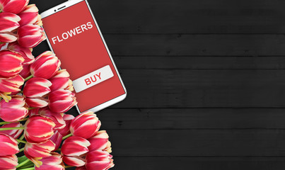 background of buying and selling flowers, red tulips on the table and the phone. - 181538857