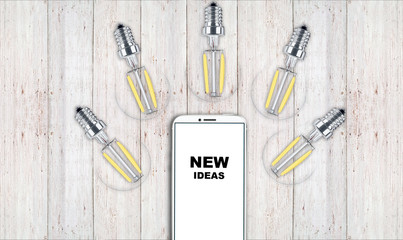 new ideas. telephone on the table and light bulbs. background for ideas - 181539207