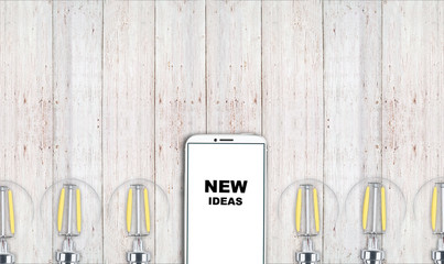 new ideas. telephone on the table and light bulbs. background for ideas - 181539421