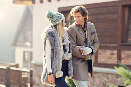 Happy couple walking outdoors in winter