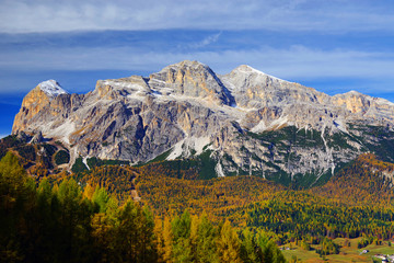 Scenic view of the Tofane Group and golden larch in sunlit at autumn morning. Dolomites, South Tyrol. Italy