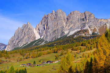Scenic view of the Tofane Group and golden larch in sunlit at autumn morning. Dolomites, South...