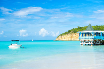 Sea beach with boat and shelter in st johns, antigua