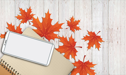 notebook, phone are lying on a wooden table with yellow, autumn leaves - 181540281