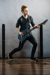 Obraz premium Young man playing electric guitar