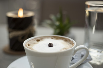 Coffee cream milk in bar romantic candle close top view beans