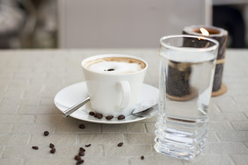Coffee cream milk in bar romantic candle close top view beans