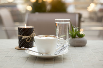 Coffee cream milk in bar romantic candle close top view beans