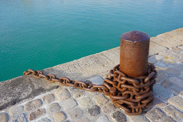  Strong brown chain stay water side at the harbor.