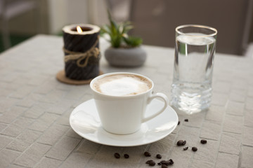 Coffee cream milk in bar romantic candle close top view beans