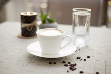 Coffee cream milk in bar romantic candle close top view beans