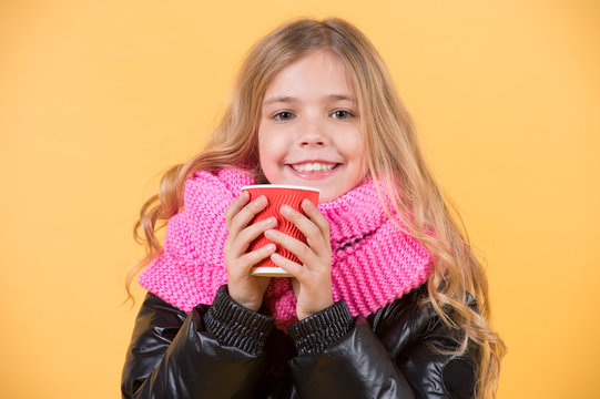 Child smile with red cup on orange background