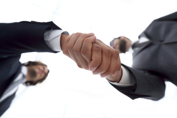 Two business people are holding hands to business cooperation.