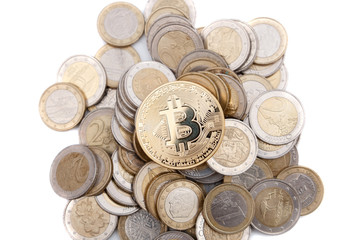 golden bitcoin on stack of euro coins on white background