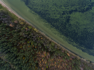 Aerial view over big lake Dusia in Lithuania, during cloudy Autumn day.